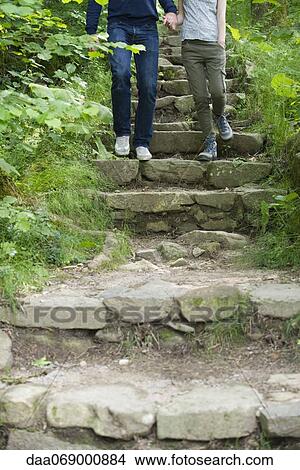 Couple walking down stone steps in woods View Large Photo Image Picture - Couple walking down stone steps in woods. Fotosearch