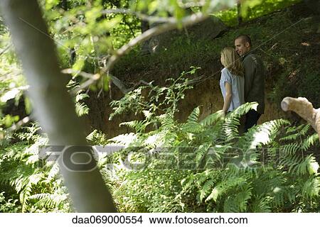 Couple walking in woods View Large Photo Image Picture - Couple walking in woods. Fotosearch