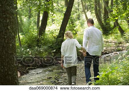 Picture - Couple walking in woods. Fotosearch