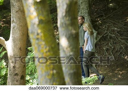 Stock Photo - Couple walking in woods. Fotosearch