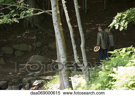 Stock Photography - Couple walking in woods. Fotosearch