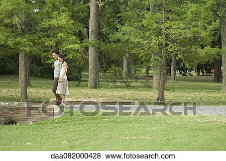 Stock Photo - Couple walking together in park. Fotosearch