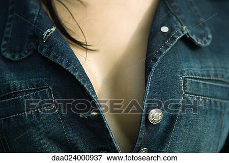 Stock Photo - Cropped view of woman's cleavage, close-up. Fotosearch