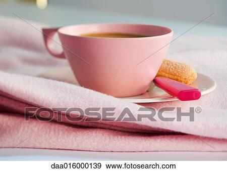 Cup of coffee on saucer with spoon and ladyfinger cookie View Large Photo Image Stock Photo - Cup of coffee on saucer with spoon and ladyfinger cookie. Fotosearch
