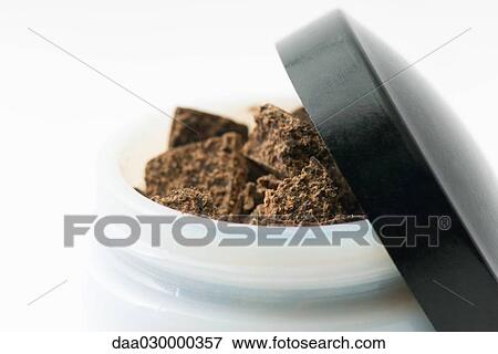 Dark chocolate in small container, close-up View Large Photo Image Stock Photo - Dark chocolate in small container, close-up. Fotosearch
