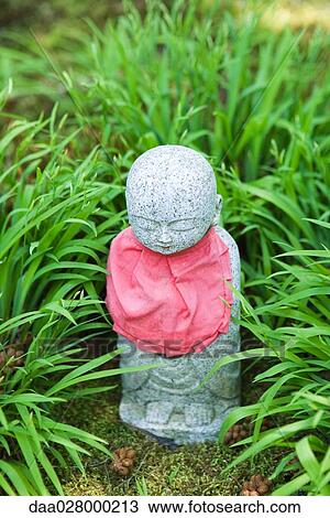 Devotional statuette in grass, close-up View Large Photo Image Stock Image - Devotional statuette in grass, close-up. Fotosearch