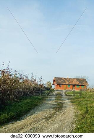 Stock Image - Dirt road and farmhouse. Fotosearch