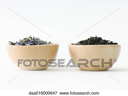 Stock Photo - Dried lavender and tea leaves in bowls, side by side. Fotosearch