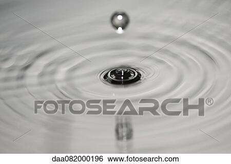 Drop hitting surface of water View Large Photo Image Stock Photograph - Drop hitting surface of water. Fotosearch