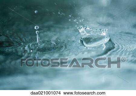 Picture - Drops of water hitting surface of water. Fotosearch