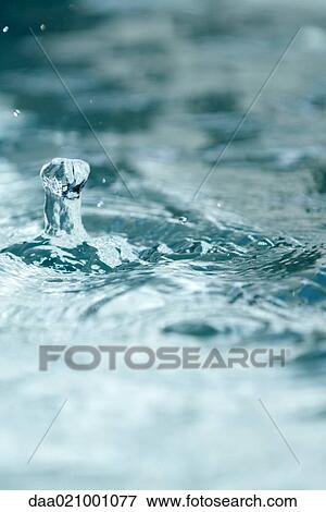 Stock Photo - Drops of water hitting surface of water. Fotosearch