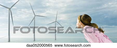 Ecology concept, girl blowing on blades of wind turbines View Large Photo Image Stock Photography - Ecology concept, girl blowing on blades of wind turbines. Fotosearch