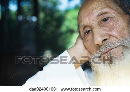 Elderly man leaning head against hand, looking away, close-up View Large Photo Image Stock Image - Elderly man leaning head against hand, looking away, close-up. Fotosearch