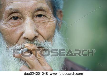 Elderly man smoking cigarette View Large Photo Image Stock Photo - Elderly man smoking cigarette. Fotosearch