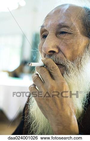 Stock Photograph - Elderly man smoking cigarette. Fotosearch