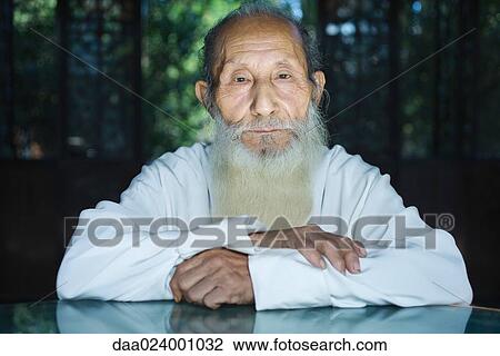 Elderly man wearing traditional Chinese clothing, arms folded, looking at camera, portrait View Large Photo Image Stock Image - Elderly man wearing traditional Chinese clothing, arms folded, looking at camera, portrait. Fotosearch