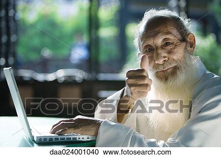 Elderly man wearing traditional Chinese clothing, using laptop, giving thumbs up to camera View Large Photo Image Stock Image - Elderly man wearing traditional Chinese clothing, using laptop, giving thumbs up to camera. Fotosearch
