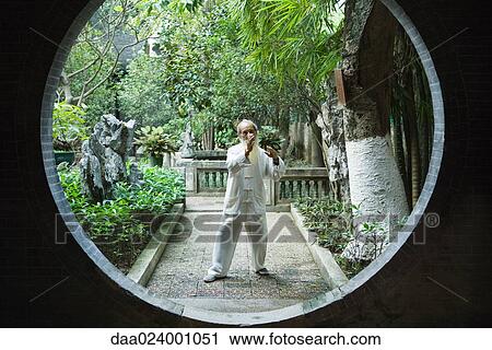 Elderly man wearing traditional Chinese clothing doing Tai Chi View Large Photo Image Stock Image - Elderly man wearing traditional Chinese clothing doing Tai Chi. Fotosearch