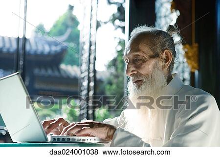 Elderly man wearing traditional Chinese clothing, using laptop View Large Photo Image Stock Photo - Elderly man wearing traditional Chinese clothing, using laptop. Fotosearch
