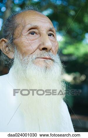 Elderly man with long white beard, low angle view, portrait View Large Photo Image Stock Image - Elderly man with long white beard, low angle view, portrait. Fotosearch