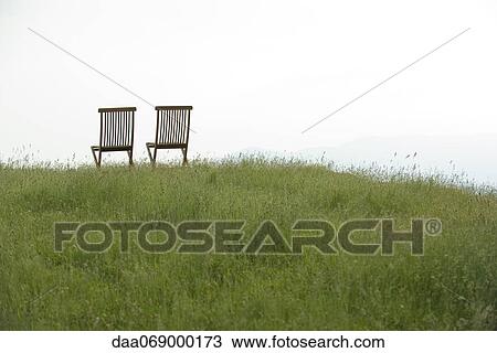 Stock Image - Empty chairs on meadow. Fotosearch