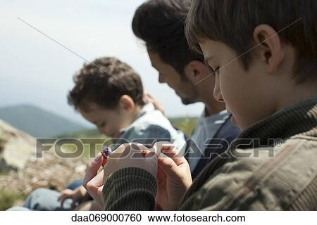 Stock Image - Fahter and children in nature. Fotosearch