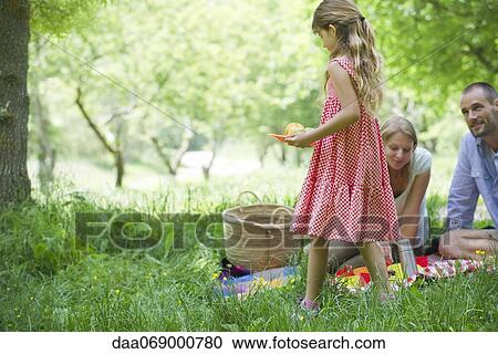 Family enjoying picnic outdoors View Large Photo Image Stock Image - Family enjoying picnic outdoors. Fotosearch