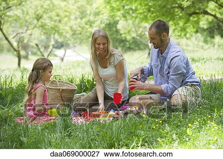 Family enjoying picnic outdoors View Large Photo Image Stock Photo - Family enjoying picnic outdoors. Fotosearch