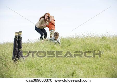 Family having fun in field View Large Photo Image Stock Image - Family having fun in field. Fotosearch