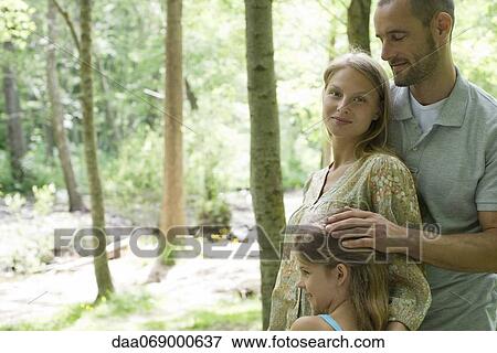 Family relaxing together in woods, portrait View Large Photo Image Stock Photo - Family relaxing together in woods, portrait. Fotosearch
