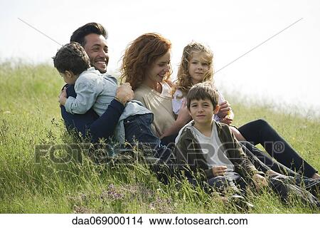 Family relaxing together outdoors View Large Photo Image Picture - Family relaxing together outdoors. Fotosearch