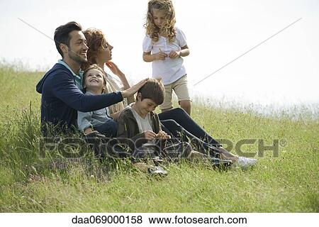 Stock Photo - Family relaxing together outdoors. Fotosearch