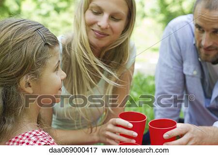 Stock Photo - Family relaxing together outdoors. Fotosearch
