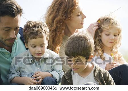 Family relaxing together outdoors View Large Photo Image Stock Photography - Family relaxing together outdoors. Fotosearch