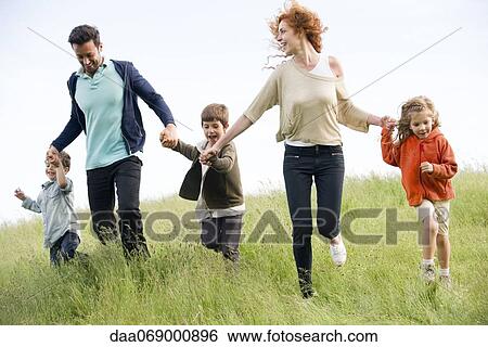 Family running together in field View Large Photo Image Stock Photograph - Family running together in field. Fotosearch