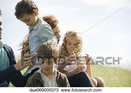 Stock Image - Family spending time together outdoors. Fotosearch