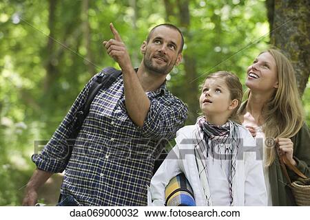 Family together outdoors, looking up in awe View Large Photo Image Stock Image - Family together outdoors, looking up in awe. Fotosearch