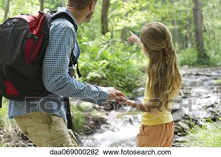 Father and daughter hiking in woods together View Large Photo Image Stock Image - Father and daughter hiking in woods together. Fotosearch