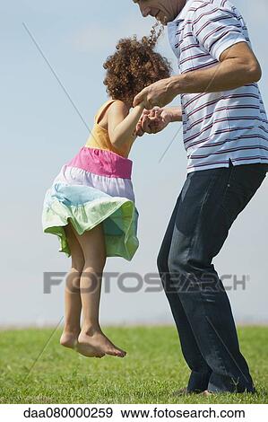 Father lifting daughter in air, side view View Large Photo Image Stock Photo - Father lifting daughter in air, side view. Fotosearch