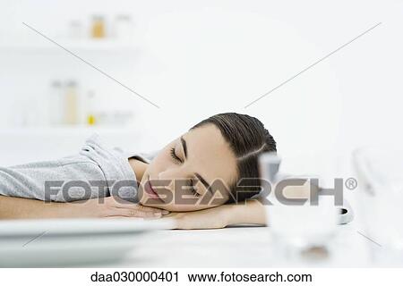Female at kitchen table, head resting on arms, eyes closed View Large Photo Image Stock Image - Female at kitchen table, head resting on arms, eyes closed. Fotosearch
