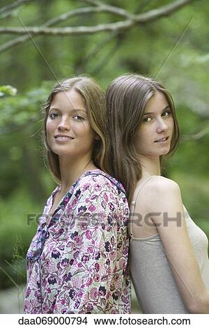 Female friends back to back, portrait View Large Photo Image Picture - Female friends back to back, portrait. Fotosearch