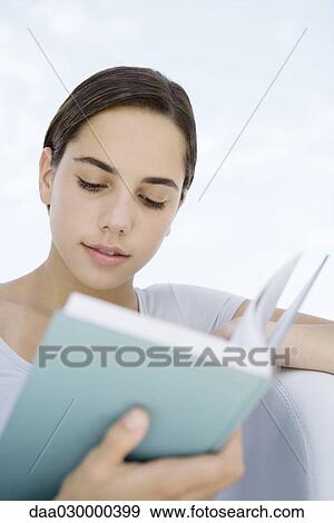 Stock Photo - Female reading book, close-up. Fotosearch