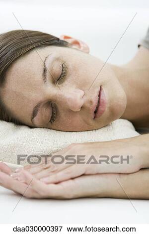 Female sleeping, eyes closed, hands clasped in front of her View Large Photo Image Stock Photo - Female sleeping, eyes closed, hands clasped in front of her. Fotosearch