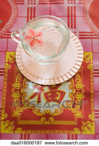 Flower-shaped candle floating in cup View Large Photo Image Stock Photo - Flower-shaped candle floating in cup. Fotosearch