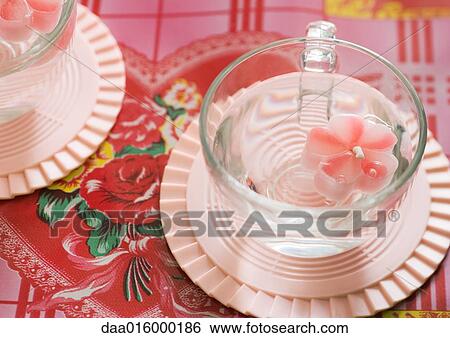 Flower-shaped candle floating in cup View Large Photo Image Stock Photograph - Flower-shaped candle floating in cup. Fotosearch