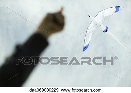 Flying a kite, low angle view View Large Photo Image Stock Photo - Flying a kite, low angle view. Fotosearch