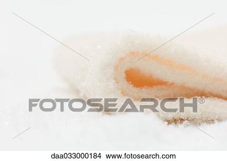 Folded blanket lying in imitation snow, close-up View Large Photo Image Picture - Folded blanket lying in imitation snow, close-up. Fotosearch