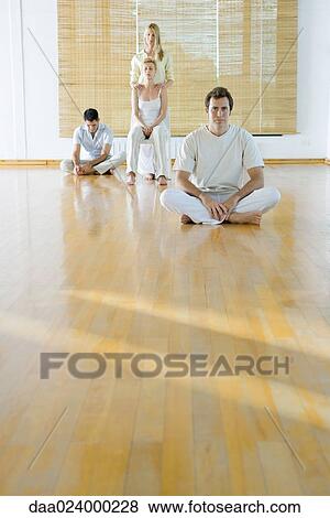 Four adults in various postures in wellness center View Large Photo Image Stock Photo - Four adults in various postures in wellness center. Fotosearch