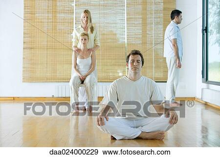 Four adults in various postures in wellness center View Large Photo Image Stock Photo - Four adults in various postures in wellness center. Fotosearch