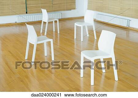 Four empty chairs on hardwood floor View Large Photo Image Stock Image - Four empty chairs on hardwood floor. Fotosearch